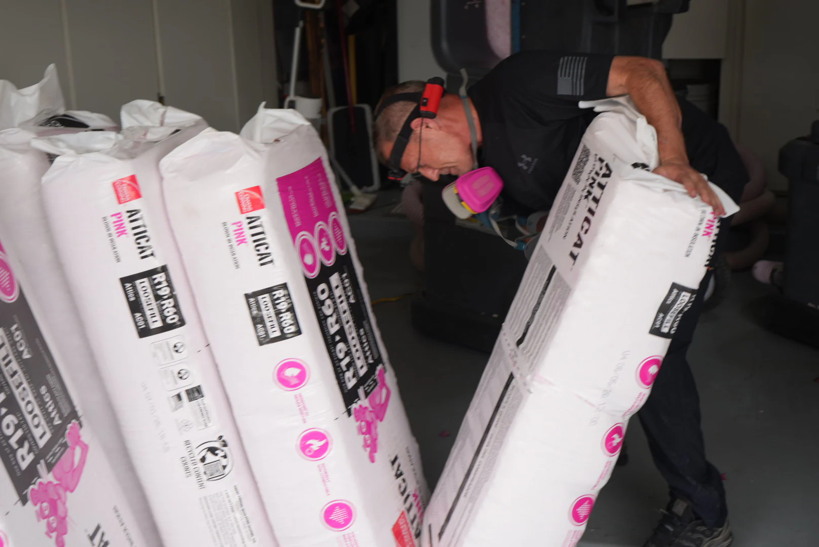 A Green Faith Solutions technician preparing insulation material for installation