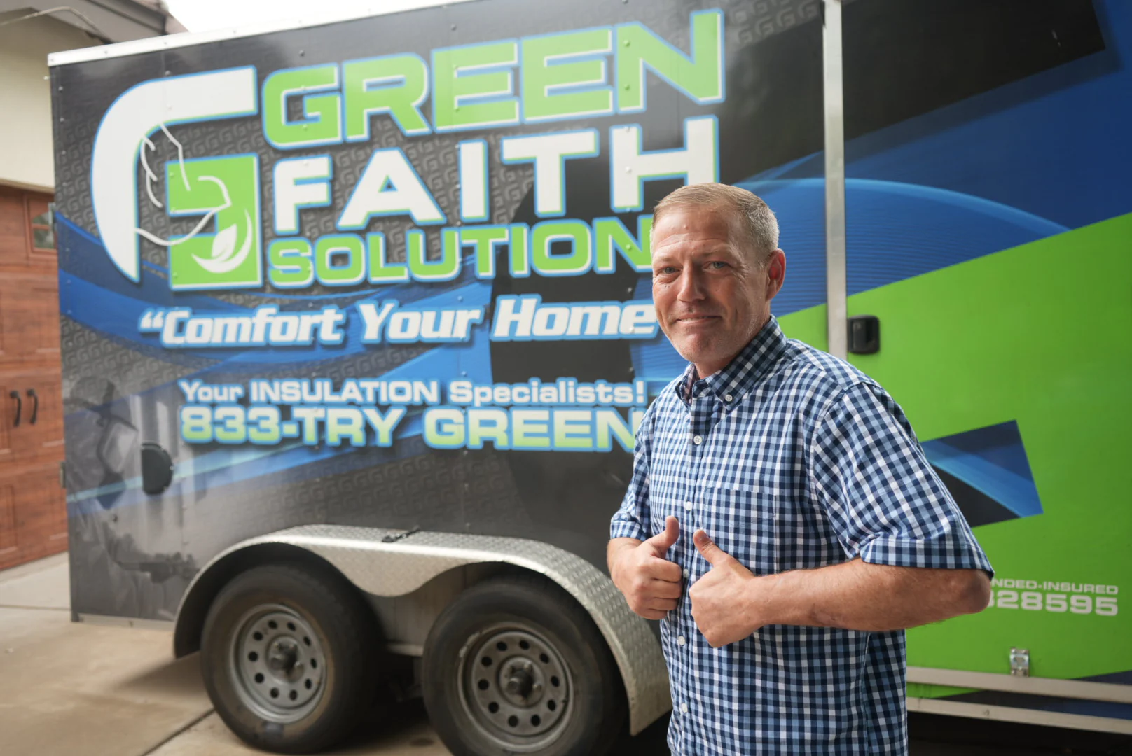 A local Green Faith Solutions operator standing beside the company trailer